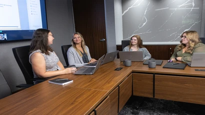 Fredona business alumni and an intern working at Lumsden and McCormick in Buffalo, NY